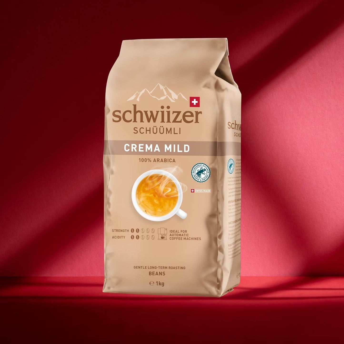 Schwiizer Schüümli Crema Mild, 100% Arabica zrnková káva jemná, harmonická a jemná, ideální pro automatické espresso stroje, síla 2/5, světle pražená, Rainforest Alliance, 1kg