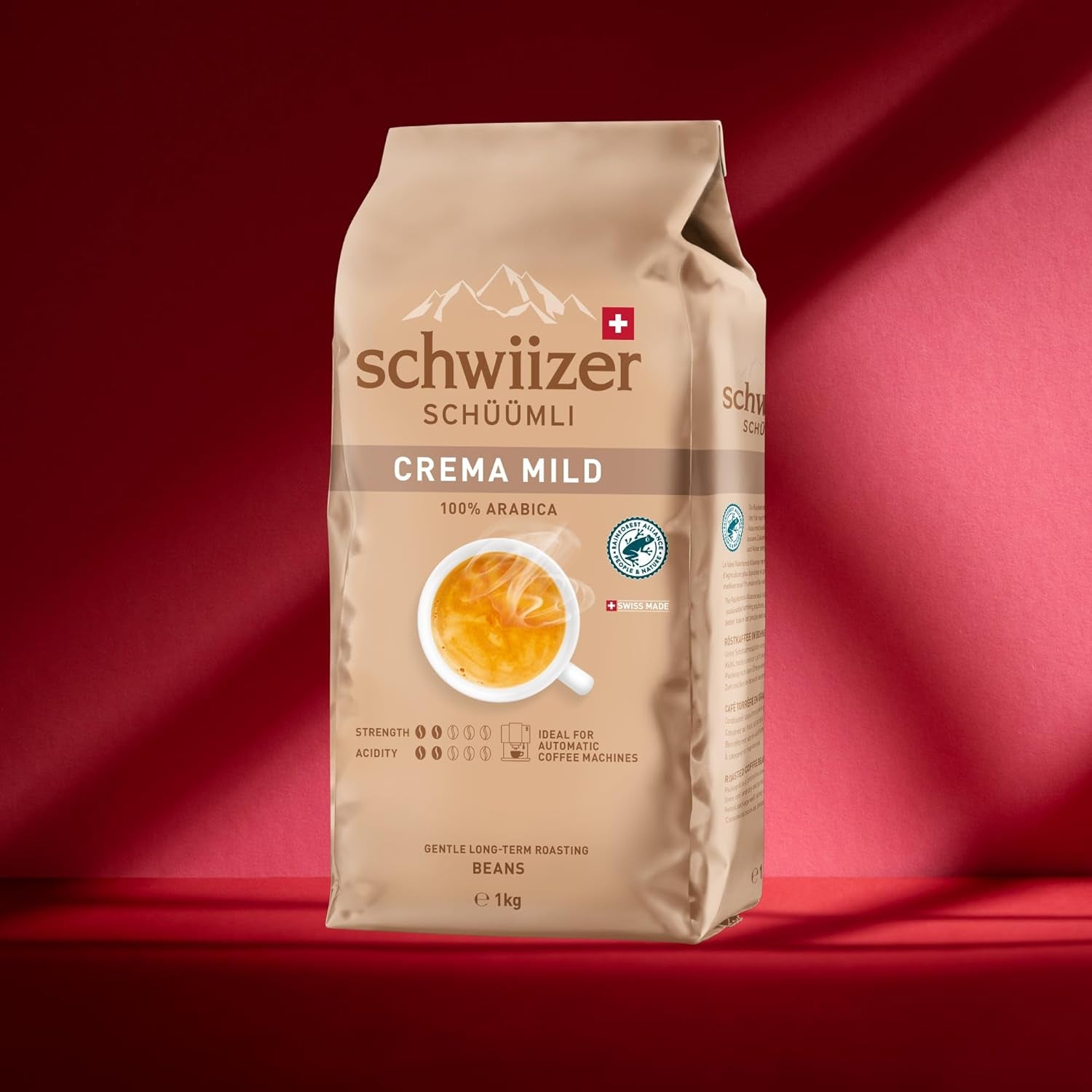 Schwiizer Schüümli Crema Mild, 100% Arabica zrnková káva jemná, harmonická a jemná, ideální pro automatické espresso stroje, síla 2/5, světle pražená, Rainforest Alliance, 1kg