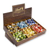 Lindor Čokoláda Top Prezentace | 1718 g a čokoládové tyčinky s marcipánem | 25 barů x 50 g v počítadle | 1250 g | Čistý marcipán potažený hořkou čokoládou | Čokoládové tyčinky